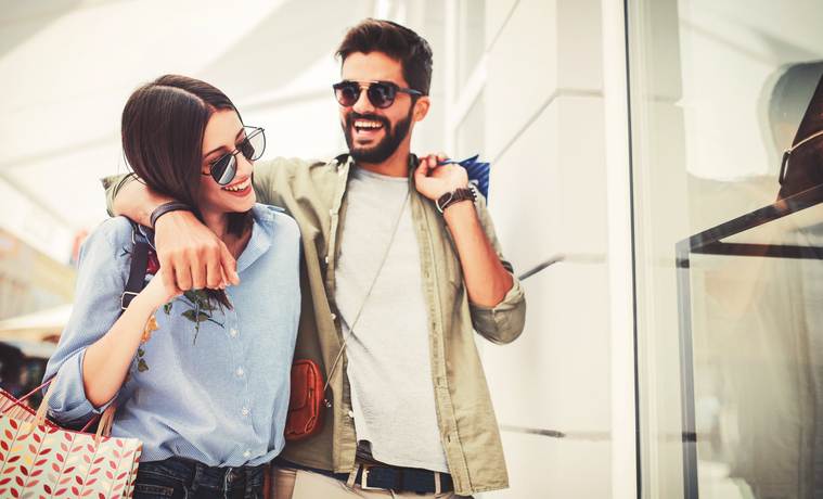 Young couple in shopping. Consumerism, love, dating, lifestyle concept Young couple in shopping. Consumerism, love, dating, lifestyle concept