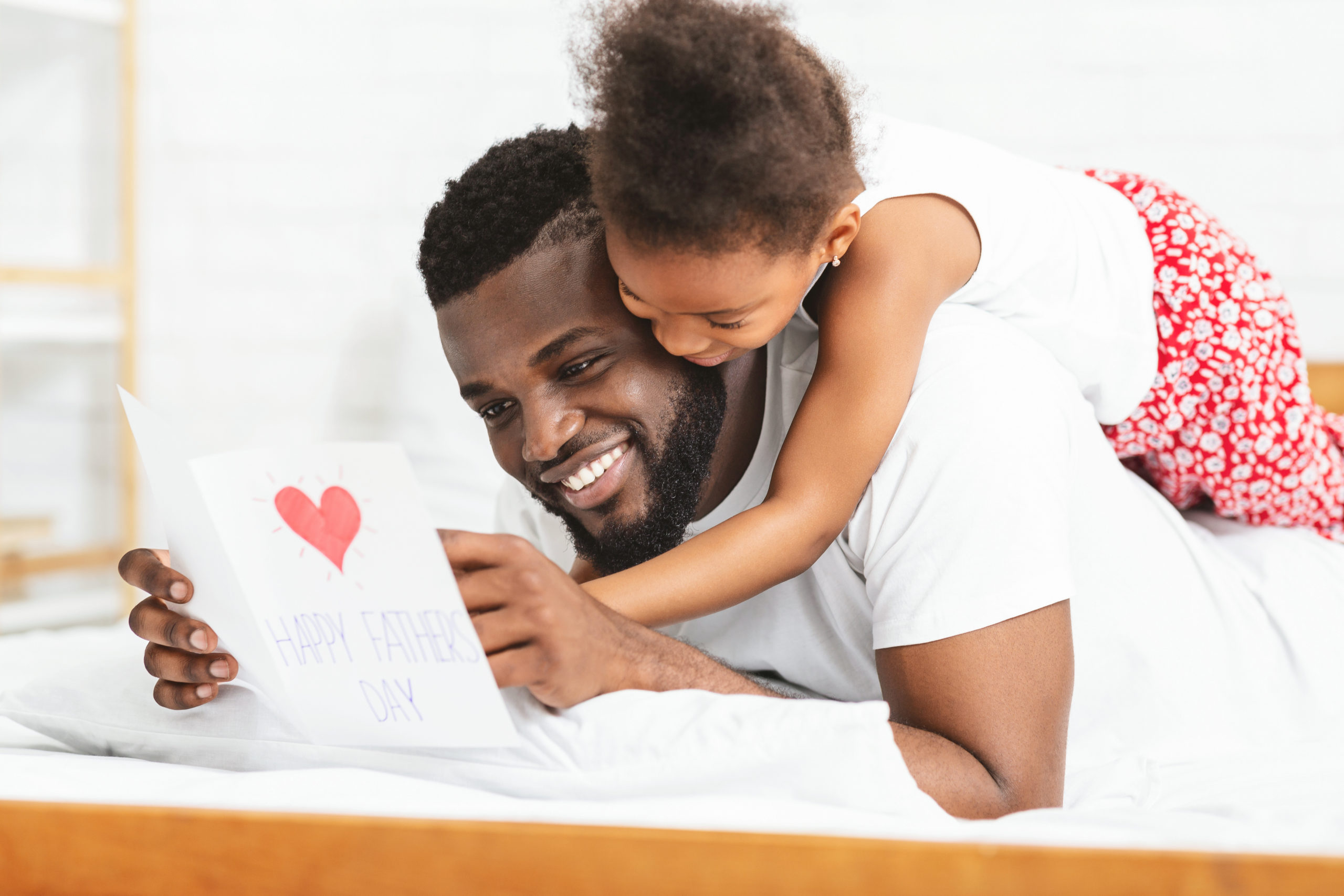 Little black girl celebrating Father's Day with daddy