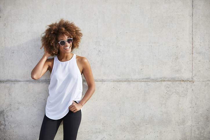 Happy woman wearing tank top and sunglasses Happy woman wearing tank top and sunglasses