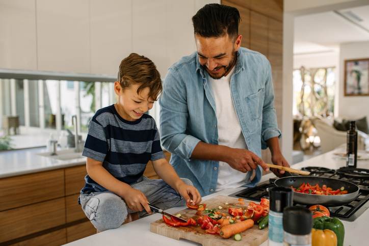Father and son preparing food in kitchen Father and son preparing food in kitchen