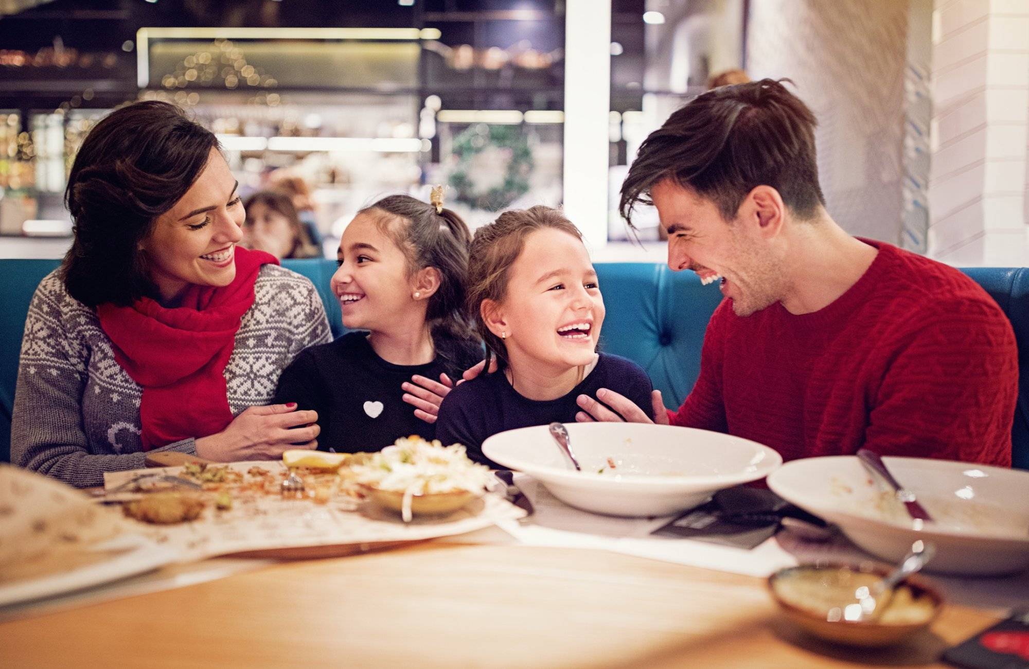 Portrait of happy family eating in the restaurant at Christmas