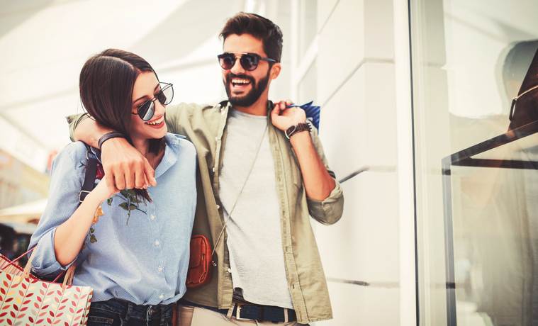 Young couple in shopping. Consumerism, love, dating, lifestyle concept