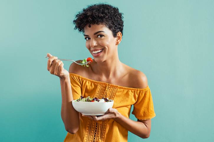 Woman eating salad