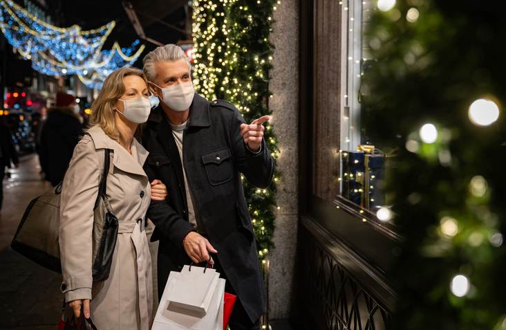 Couple Christmas shopping wearing a facemask in London Couple Christmas shopping wearing a facemask in London