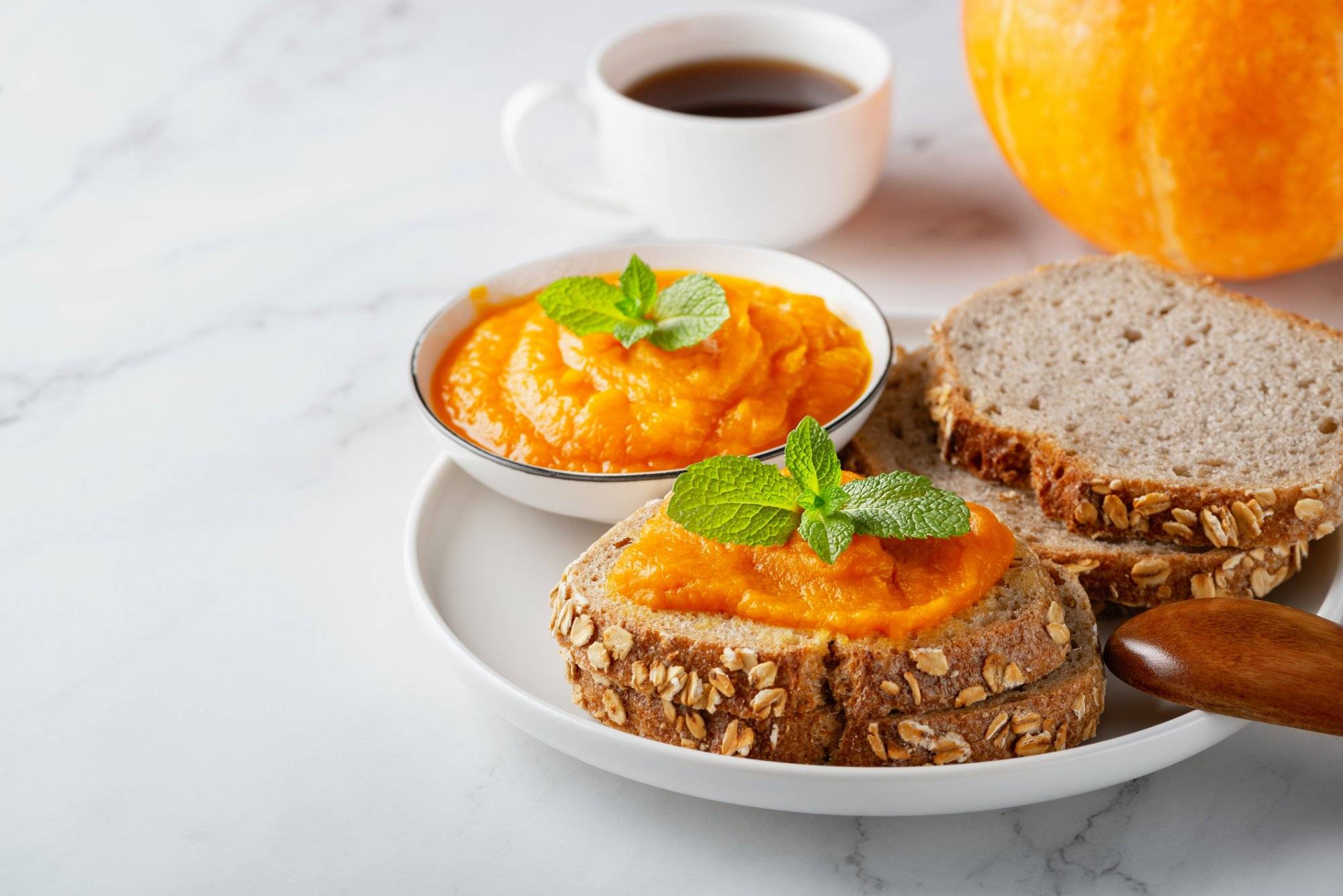 Sandwich with tasty pumpkin jam on table