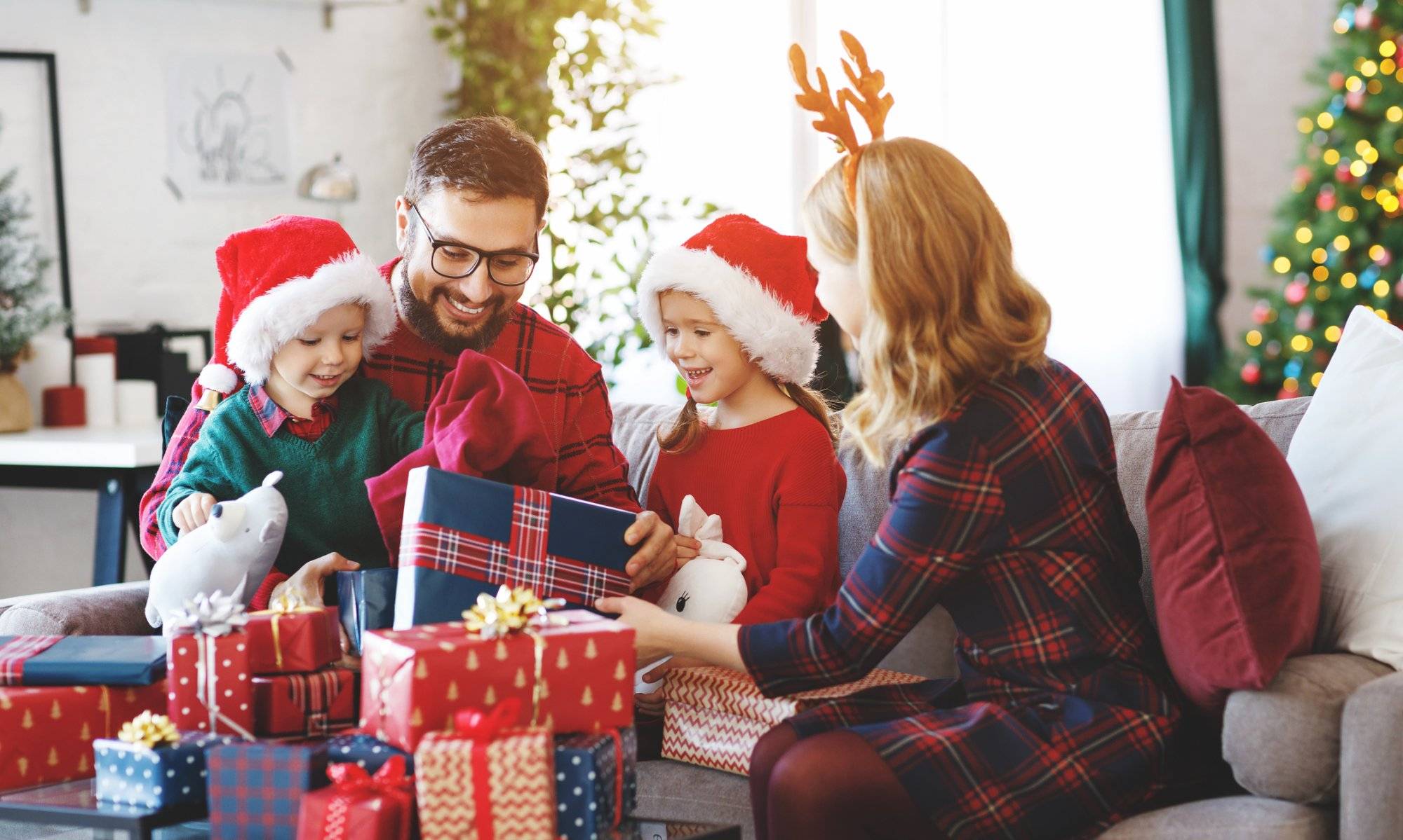 happy family parents and children open presents on Christmas morning